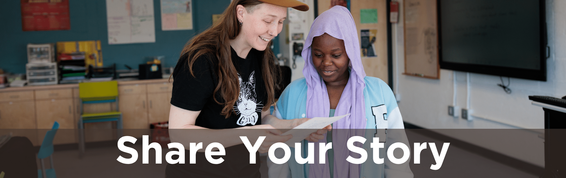 Image of teacher reading something student has written. Text: Share Your Story.